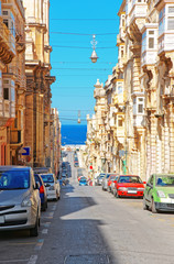 Street with traditional houses in old city center of Valletta