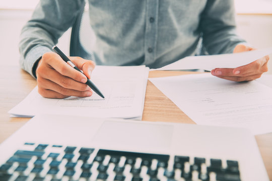 Businessman checking documents at table