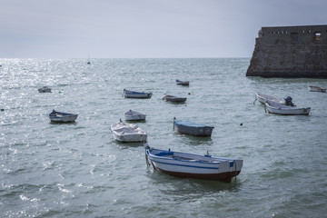 Caleta Beach and fishing boats in Cadiz, Spain