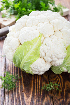 Raw organic cauliflower on wooden table
