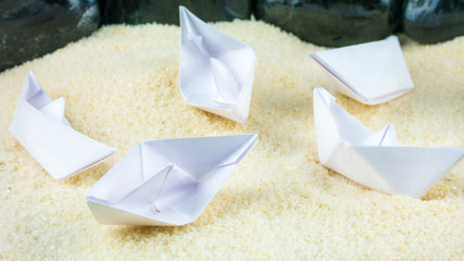Paper Ships Chaotic Laying on Sandy Bottom without Water
