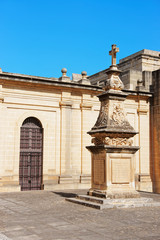 Fototapeta premium Cross monument at courtyard of St John Cathedral in Valletta
