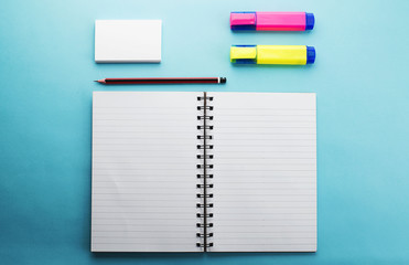 Office supplies on blue background. Mockup.