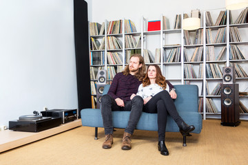 a couple on the sofa listening to music