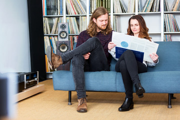 a couple taking a vinyl out of the cover to play