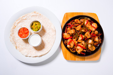 Stir fry chicken with sweet peppers and green beans in wok pan