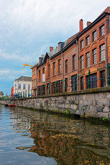 Fototapeta na wymiar Buildings on Graslei and Korenlei over Lys River in Ghent