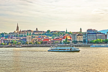 Naklejka premium Ferry in Danube River and Buda city embankment in Budapest