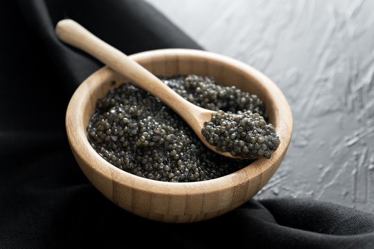 Black Caviar In Wooden Bowl On Black  Background