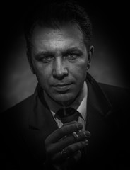 Black and white portrait of a smoking man.