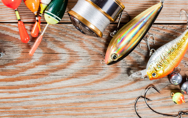 Fishing accessories on a wooden background. © Alex Ishchenko