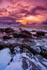Sunset on the sea rocky shore.
