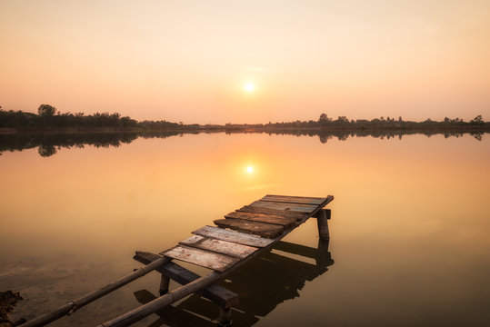 Wooden Bridge At The Lake On Sunset