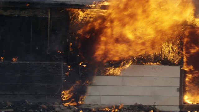 House on fire burning in slow motion