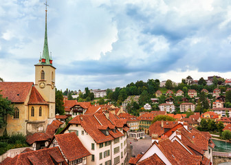 Nydegg Church and old houses rooftops in Bern