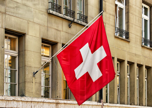 Swiss Flag Waving In Street At Old City Center Bern