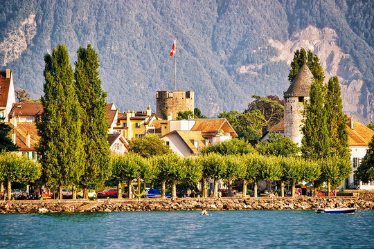 Town with towers and Alps mountains and Geneva Lake Vevey