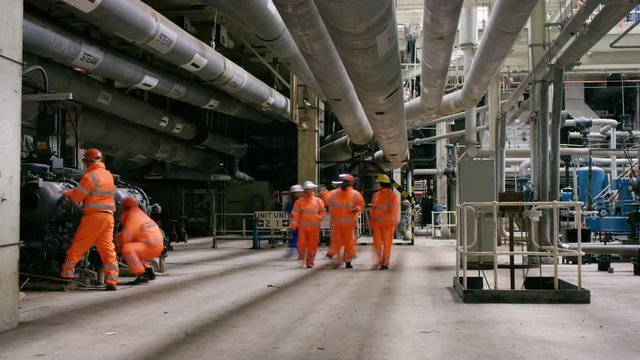  Portrait of smiling Asian engineer at work in industrial plant
