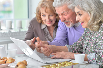 Elderly people using a laptop