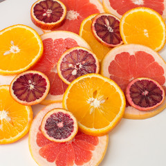 Citrus fruit background with sliced oranges , sicilian oranges grapefruit as a symbol of healthy eating and immune system boost with natural vitamins.