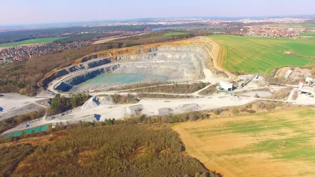   Camera flight over a open cast mine. Industrial landscape. Heavy industry from above. 

