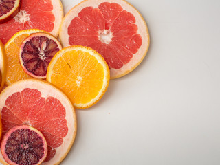 Citrus fruit background with sliced oranges , sicilian oranges grapefruit as a symbol of healthy eating and immune system boost with natural vitamins.