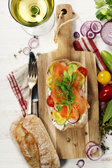 Sandwich with salmon, cucumber, cream cheese, dill and tomatoe