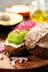 Avocado sandwich on dark rye bread made with fresh sliced avocados