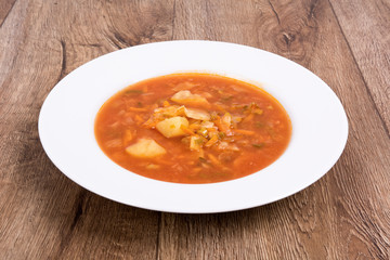 Vegetable soup on a wooden table