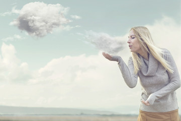 woman with magical powers creating clouds blowing