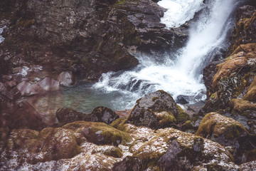 Waterfall in the forest with moss stones