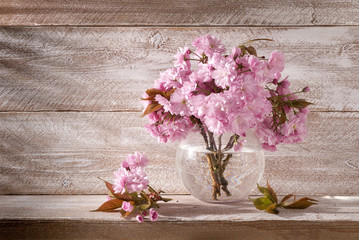 flowers in a round vase on a wooden background still life beautiful gentle pink color