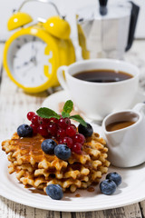 waffles with berries and caramel for breakfast, vertical closeup