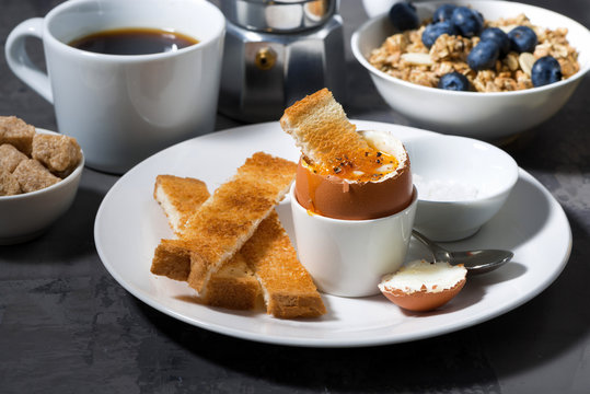 soft boiled egg, toasts and coffee for breakfast