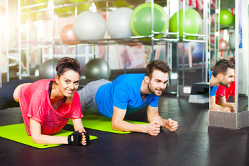 Sport - young fitness couple, crossfit training