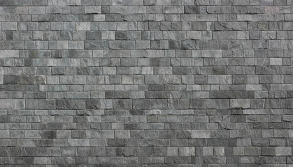 Stone wall as a background or texture. An example of masonry as a cladding of external walls.