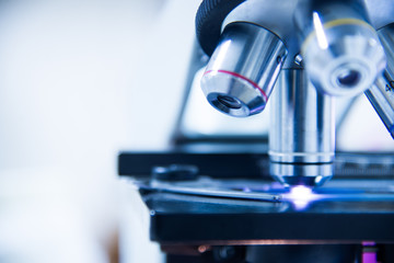 Microscope medical laboratory equipment in blue tone.