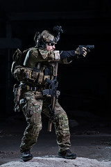 Spec ops soldier with pistol/Special Forces soldier with night vision device and gun on dark...