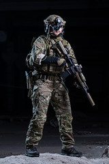 Soldier with night vision device and rifle/Soldier with night vision device,helmet with rifle on dark background