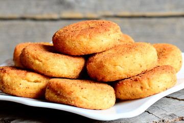 Delicious chickpea burgers on a plate and on wooden table. Fried chickpea burgers recipe. Rustic style. Closeup