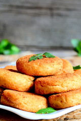 Fried vegetarian burgers on a plate. Tasty chickpea burgers decorated with parsley. Rustic style. Vertical photo