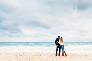 Lovers on the beach in early spring