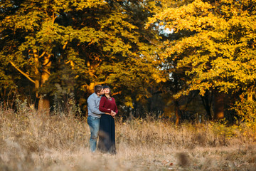 Lovers kiss on sunset in  forest