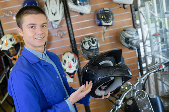 Salesman holding motorcycle helmet