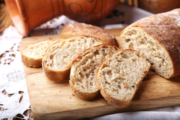 Freshly baked ciabatta bread on wooden cutting board