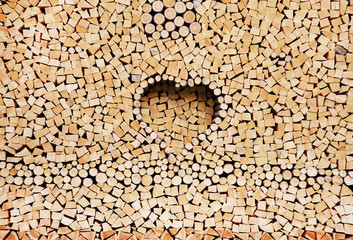Firewood background stacked in the woodpile, pile of chopped fire wood