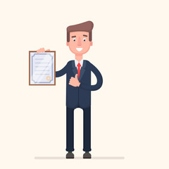Standing business man holding certificate or diploma and showing thumbs up gesture.