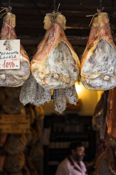 The famous Norcia's ham exposed in one of the many shops in the old town, Norcia, Italy