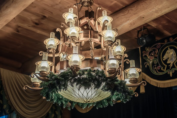 A large chandelier in a wooden house