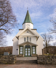 Fototapeta na wymiar White church and blue sky with small clouds in Norway, vertical image